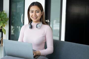 Wall Mural - Young woman working and studying with laptop computer at home.