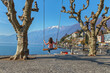 Young woman on a swing by the lake of Lago Maggiore, Ascona, Switzerland