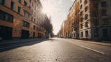 Fototapeta Uliczki - an empty city street lined with tall buildings