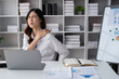© Parichat - Asian businesswomen suffer from shoulder pain from working too much in an office.