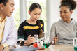 © winnievinzence - Students in science class doing chemical experiment in laboratory. Girl mixing chemistry in test tube. learning and education concept. Teacher watching and supporting kids