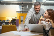 © Svitlana - Male and female discussing work process in the office