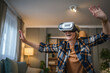 © Miljan Živković - Woman mature senior female at home enjoy virtual reality VR headset