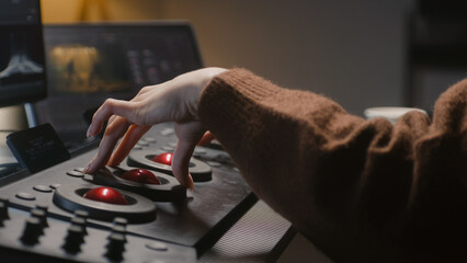 Fototapete - The editor uses digital color grading control panel. Colorist makes video or photo color correction on computer in studio. Tablet with footage and program interface with RGB color wheels at background