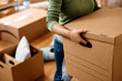 © Drazen - Close up of woman moving into new apartment.