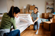 © Drazen - Young women wrapping furniture on their moving day.