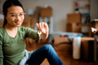 © Drazen - Close up of Asian woman holds key of her new home.