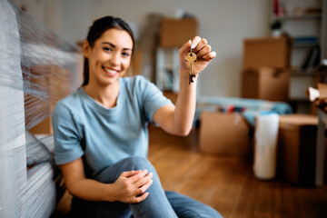 Wall Mural - Close up of woman with key of her new apartment.