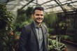 © Robert MEYNER - Portrait of a handsome young man in a business suit in a greenhouse