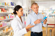 © JackF - Female specialist is helping male client choose medicine in pharmacy