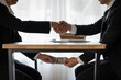© Phimwilai - business people shaking hands and Give an under-the-table bribe to an attorney to help a lawyer win a court case. Bribery and Kickback Ideas Fraud and Fraud