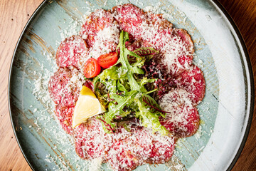 Wall Mural - carpaccio meat with parmesan cheese and arugula