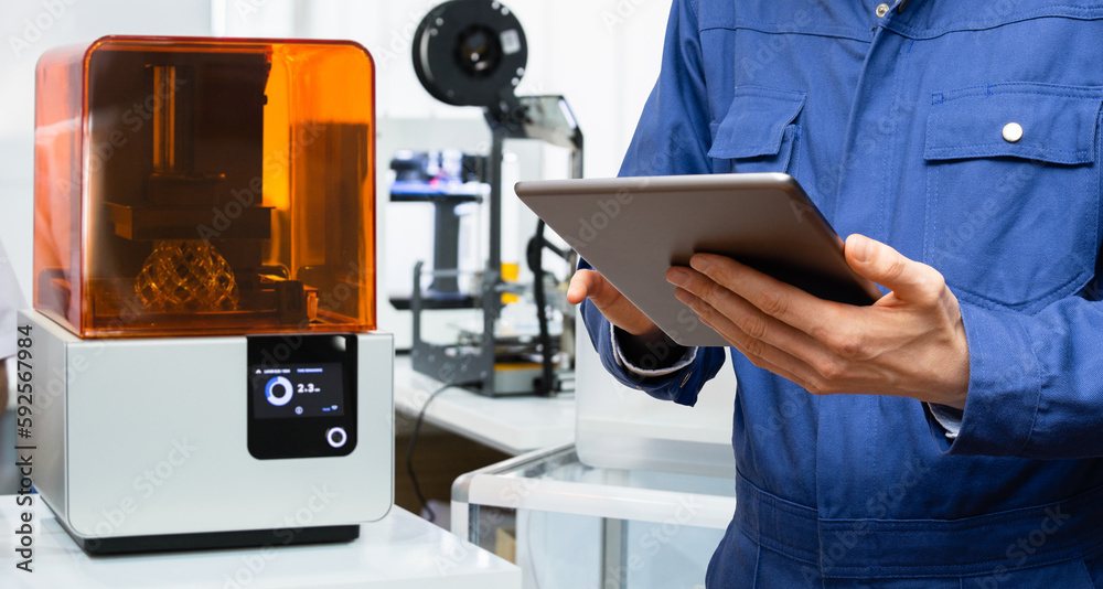 Engineer using digital tablet to program 3d printer Stock Photo | Adobe ...
