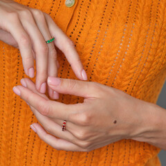 Wall Mural - Woman Jewelery concept. Woman hands close up wearing rings, earrings.