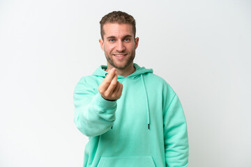 Wall Mural - Young handsome caucasian man isolated on white background making money gesture