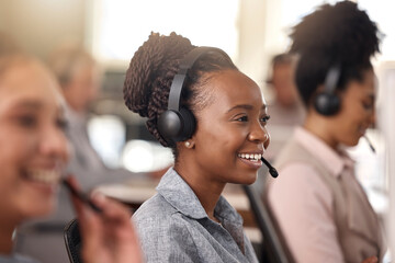 Canvas Print - Call center, black woman and smile on face for sales, telemarketing and support. Professional female consultant or agent with a headset, mic and team for customer service, crm or help desk for advice