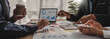 © wichayada - Business People Meeting using laptop computer,calculator,notebook,stock market chart paper for analysis Plans to improve quality next month. Conference Discussion Corporate Concept..