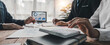 © wichayada - Business People Meeting using laptop computer,calculator,notebook,stock market chart paper for analysis Plans to improve quality next month. Conference Discussion Corporate Concept..