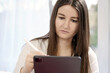 © Dan Race - Woman or student at home working with a pen on her tablet PC