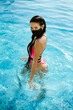 © shevtsovy - woman relax in swimming pool wearing face mask self isolation concept. Sexy female in swimsuit wear protective face mask on isolation lockdown during virus covid-19 pandemia. Summer travel concept.