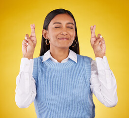 Wall Mural - Hope, fingers crossed and woman model in studio wishing for success, winning or achievement. Happiness, smile and excited Indian female with a luck hand gesture or emoji isolated by yellow background