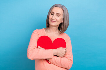 Sticker - Photo of sweet adorable lady dressed coral shirt hugging big red heart closed eyes isolated blue color background