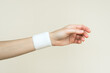 a woman wears an elastic bandage on her wrist. wrist pain and wrist injury concept