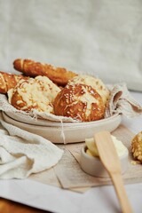 Poster - Closeup of delicious Laugen buns with salt and butter on a white table