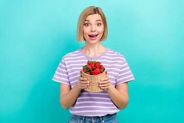 Sticker - Photo of astonished girl with straight hairstyle dressed stylish t-shirt hold basket of strawberry isolated on turquoise color background