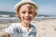 © ADDICTIVE STOCK - Generative AI illustration of little boy with blond hair and hat smiling and looking at camera while spending time on sandy beach