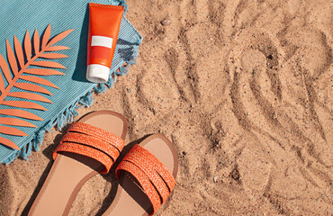 bright summer beach vacation or travel lifestyle concept flat lay with suncream and a flip flops on 