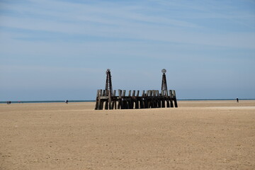 Canvas Print - Old wooden pier On St Anne's beach in Lytham Lancashire England. Blue sky background and no people. 