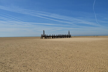 Poster - Old wooden pier On St Anne's beach in Lytham Lancashire England. Blue sky background and no people. 