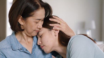 Middle aged asia people old mom love care trust comfort help young teen talk crying stress relief at home. Mum as friend listen adult child woman feel pain sad worry of broken heart life crisis issues