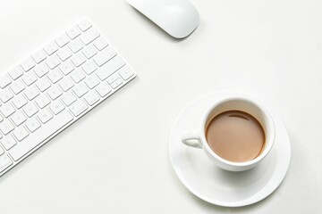 Sticker - White cup of coffee next to a keyboard and computer mouse