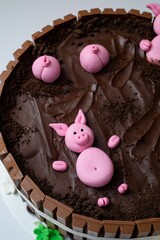 Sticker - Beautiful closeup of a chocolate cake with a design of pigsty with swines