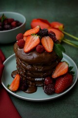 Poster - Closeup view of chocolate pancakes with strawberries topping