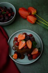 Canvas Print - Top view of a chocolate pancake decorated with berries