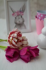 Poster - Closeup view of beautiful flowers on a table decorated with bunnies