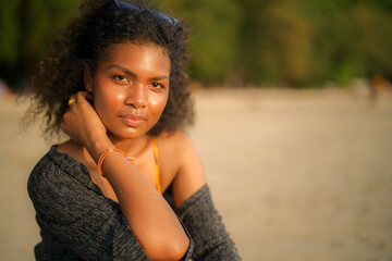 Wall Mural - African woman sitting on bench beach at tropical beach. Young traveler wearing yellow bikini and chilling out the beauty of the Nature. Wanderlust and travel concept.