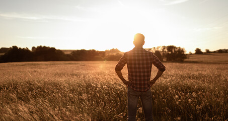 Young thoughtful man stoping to enjoy the sunrise in the country side feeling at peace in nature 