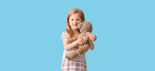 Canvas Print - Funny little girl with teddy bear on light blue background