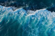 Spectacular aerial top view background photo of blue ocean sea water white wave splashing in the deep sea. Drone photo