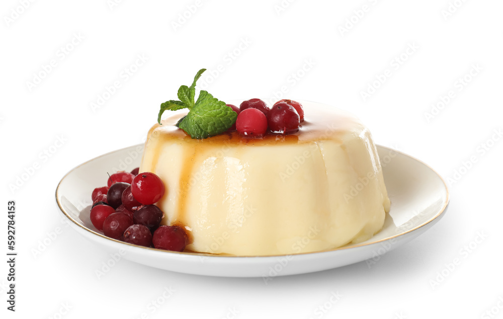 Plate with delicious pudding, mint and cranberries covered by caramel syrup isolated on white background