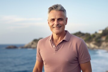 Wall Mural - Full-length portrait photography of a satisfied man in his 40s wearing a sporty polo shirt against a beach background. Generative AI