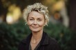 © Robert MEYNER - Portrait of beautiful mature woman with short blond hair in the park