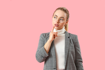 Poster - Thoughtful young businesswoman on pink background