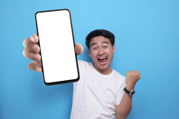 asian man looking to camera, smiling and showing empty blank white copy space phone mock up template
