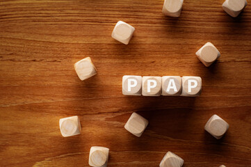 Poster - There is wood cubes with the word PPAP. It is an abbreviation for  as eye-catching image.