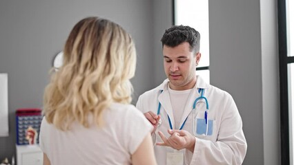 Canvas Print - Man and woman doctor and patient having consultation at clinic